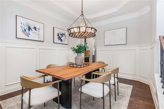2544 Thompson Rd NE, Brookhaven, GA 30319 - dining area with a decorative wall, a tray ceiling, dark wood-style flooring, crown molding, and a wainscoted wall