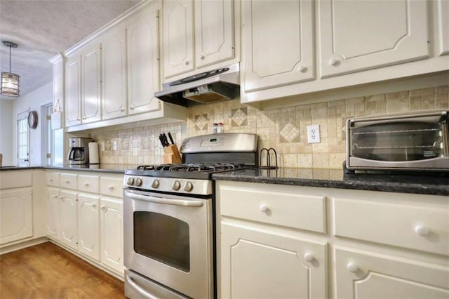 kitchen with stainless steel range with gas stovetop, white cabinetry, tasteful backsplash, decorative light fixtures, and wood-type flooring