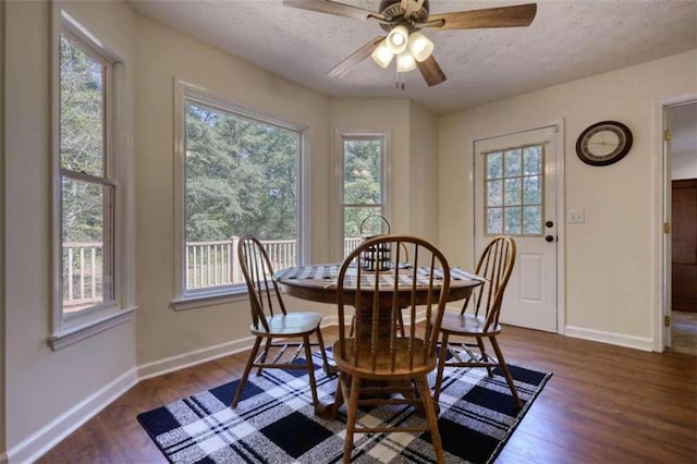 dining space with a textured ceiling, dark wood-type flooring, and ceiling fan