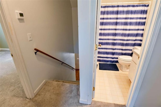 bathroom with walk in shower, tile patterned flooring, vanity, and toilet