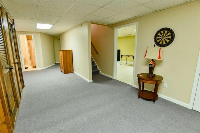 interior space with carpet flooring and a drop ceiling