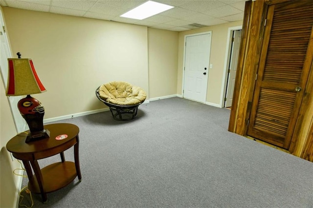 sitting room featuring carpet and a paneled ceiling