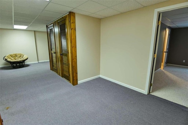 interior space with a paneled ceiling