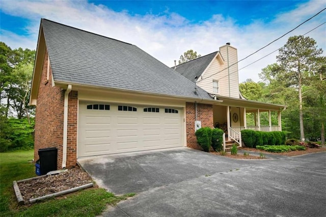 view of front of home with a garage and a porch