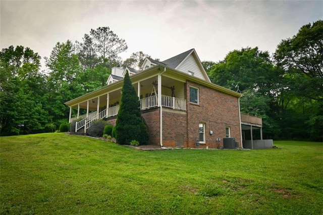 view of side of home with a balcony and a lawn