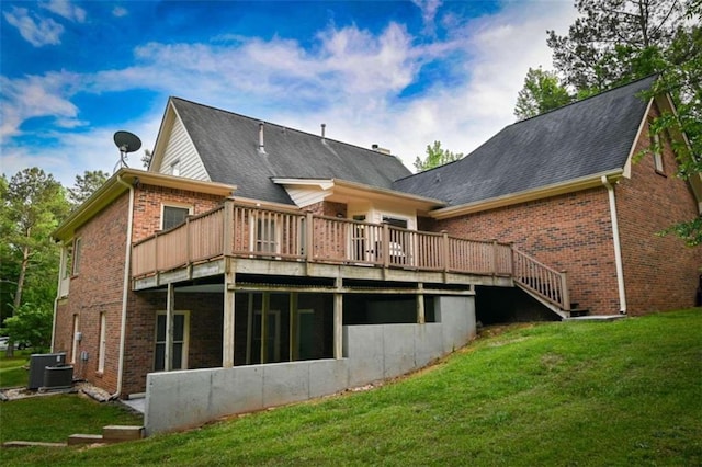 rear view of property with a wooden deck, central AC, and a yard