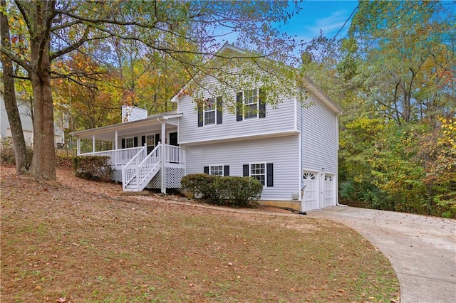 view of front of property featuring covered porch and a garage