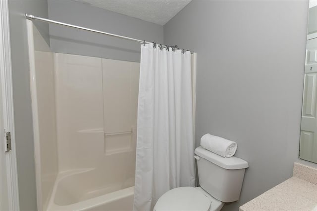 bathroom featuring a textured ceiling, shower / tub combo, and toilet