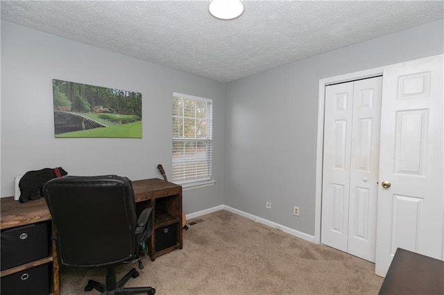 office featuring a textured ceiling and light colored carpet