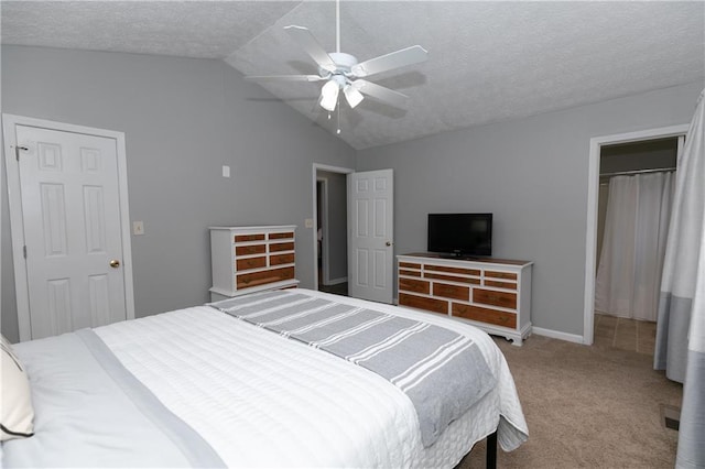 bedroom featuring a textured ceiling, carpet floors, ceiling fan, and vaulted ceiling