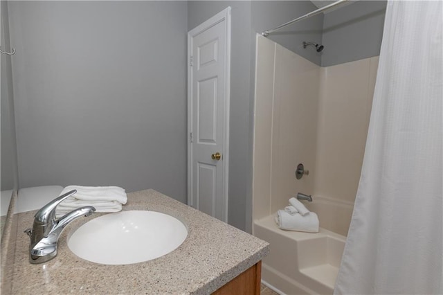 bathroom featuring shower / bath combo with shower curtain and vanity