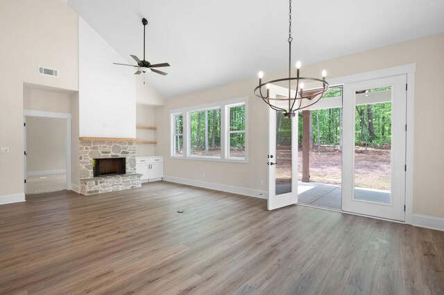 160 Doris Path, Dallas, GA 30157 - unfurnished living room with wood finished floors, a chandelier, baseboards, a stone fireplace, and a ceiling fan