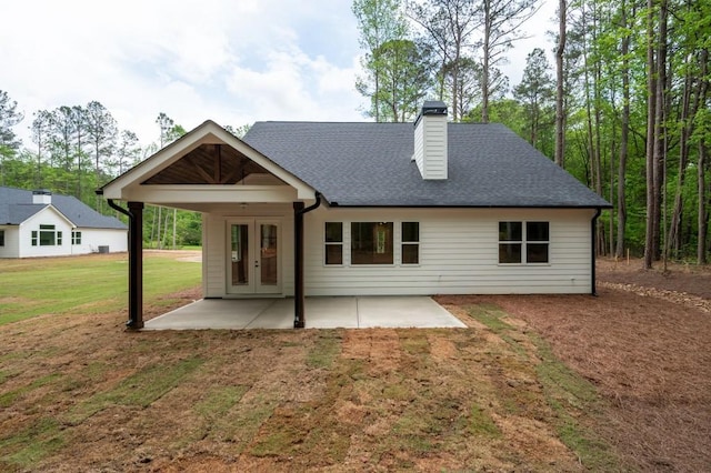 160 Doris Path, Dallas, GA 30157 - back of house with a lawn, a chimney, a patio area, and roof with shingles