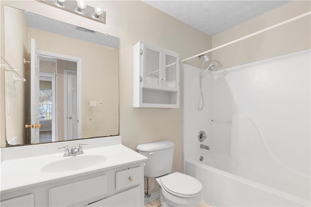 full bathroom with toilet, vanity, a textured ceiling, and bathing tub / shower combination