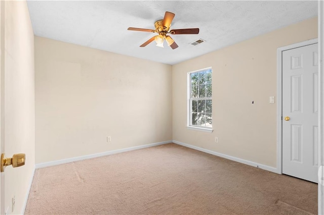 empty room with ceiling fan and light colored carpet