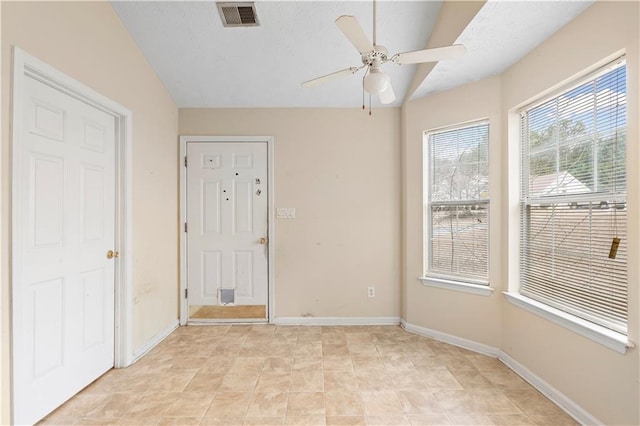 spare room with ceiling fan and vaulted ceiling