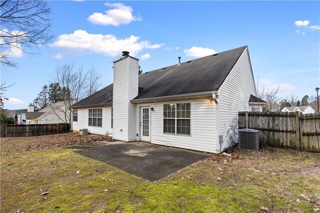 back of house featuring a patio, cooling unit, and a lawn