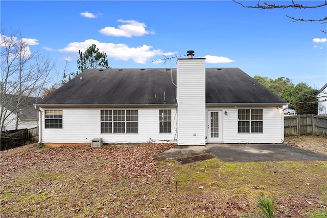 back of house with a lawn and a patio area