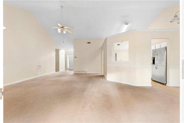 spare room featuring lofted ceiling, light carpet, and ceiling fan