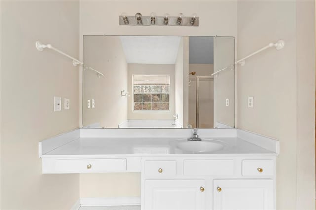 bathroom featuring walk in shower and vanity