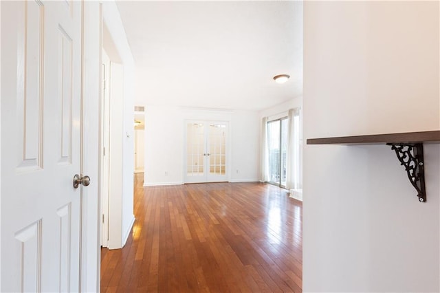 hallway with wood-type flooring and french doors