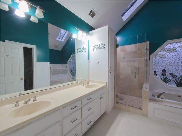 bathroom with separate shower and tub, vaulted ceiling with skylight, vanity, and tile patterned flooring