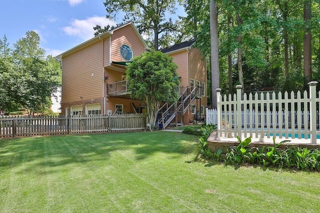 view of yard featuring a garage and a fenced in pool