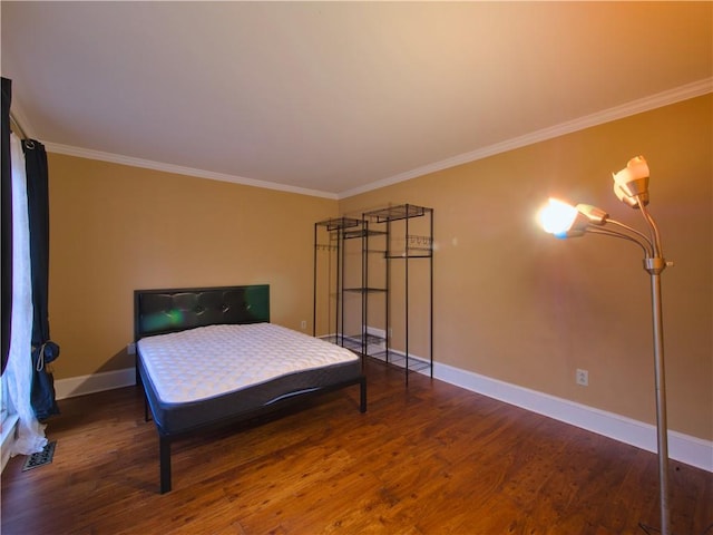 bedroom featuring crown molding and dark wood-type flooring