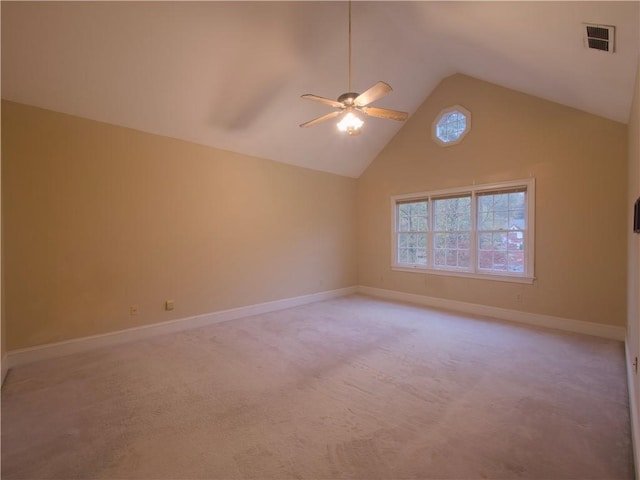 empty room with light carpet, high vaulted ceiling, and ceiling fan