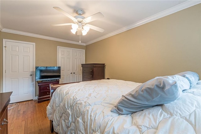 bedroom with ceiling fan, wood-type flooring, and ornamental molding