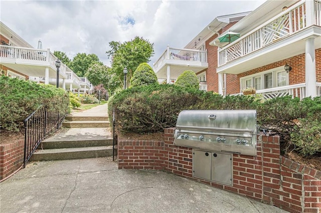 view of patio / terrace featuring area for grilling and a balcony