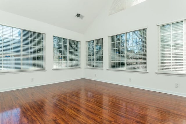 unfurnished sunroom with visible vents, a healthy amount of sunlight, and lofted ceiling