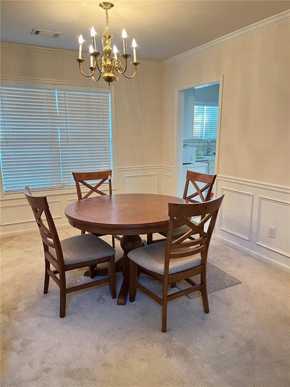 dining space featuring light carpet, ornamental molding, visible vents, and a decorative wall