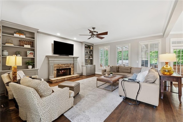 4750 Freeport Bay NE, Roswell, GA 30075 - living room with dark wood-type flooring, ornamental molding, a ceiling fan, built in features, and a fireplace