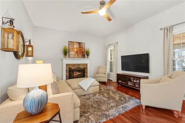 living room with ceiling fan, wood finished floors, and a fireplace