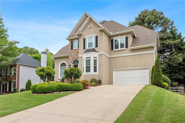traditional home featuring stucco siding, a garage, driveway, and a front lawn