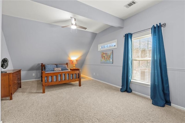 bedroom with vaulted ceiling, light carpet, multiple windows, baseboards, and ceiling fan