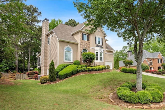 traditional home featuring stucco siding, a chimney, and a garage
