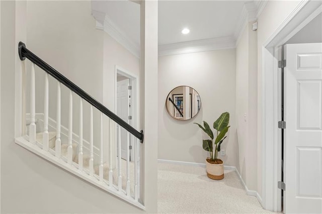 staircase featuring ornamental molding and baseboards
