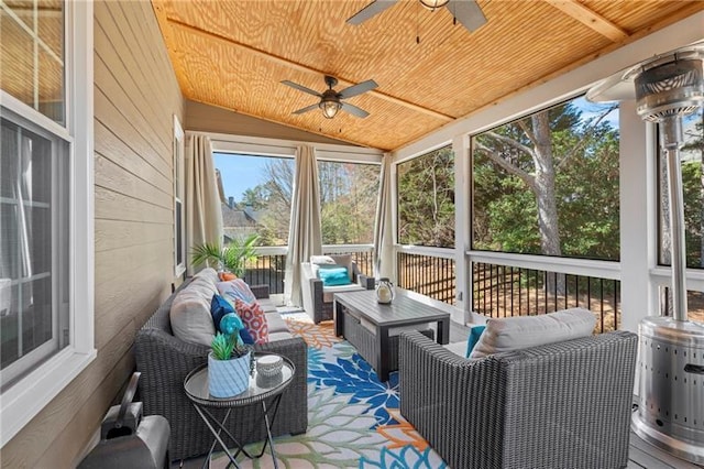 sunroom / solarium featuring a ceiling fan, outdoor lounge area, and vaulted ceiling