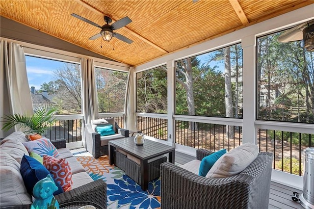 sunroom / solarium featuring a ceiling fan, an outdoor living space, plenty of natural light, and vaulted ceiling