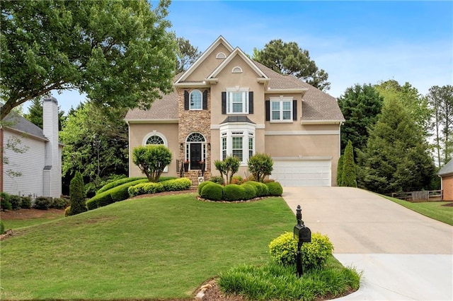 traditional-style house with stucco siding, driveway, and a front lawn