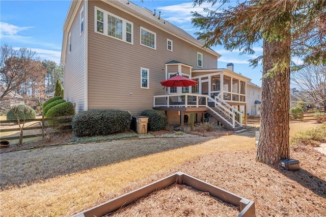 back of house with a sunroom, stairs, fence, and a deck