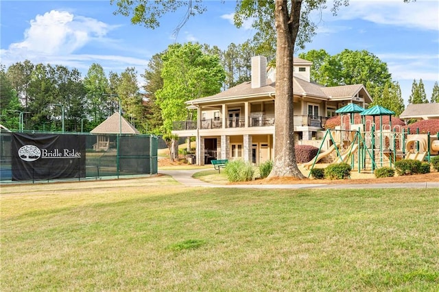 rear view of property with a chimney and a balcony