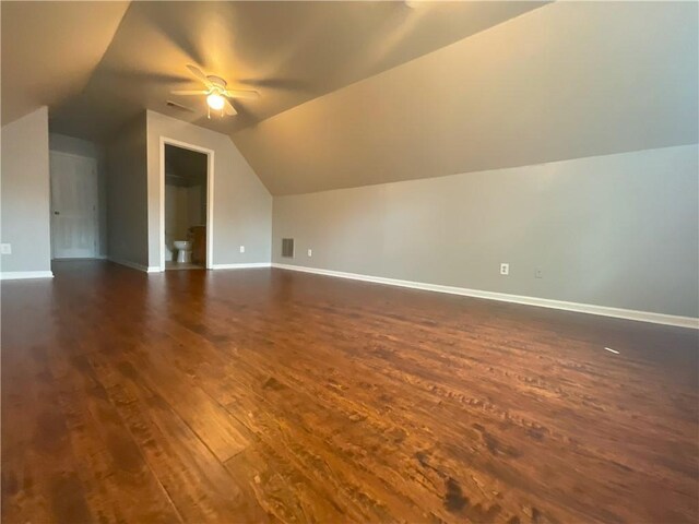 additional living space featuring lofted ceiling, dark hardwood / wood-style floors, and ceiling fan