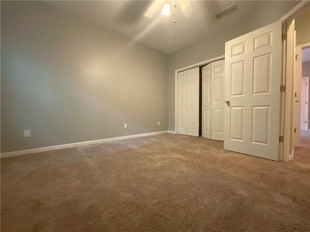 unfurnished bedroom featuring ceiling fan and carpet