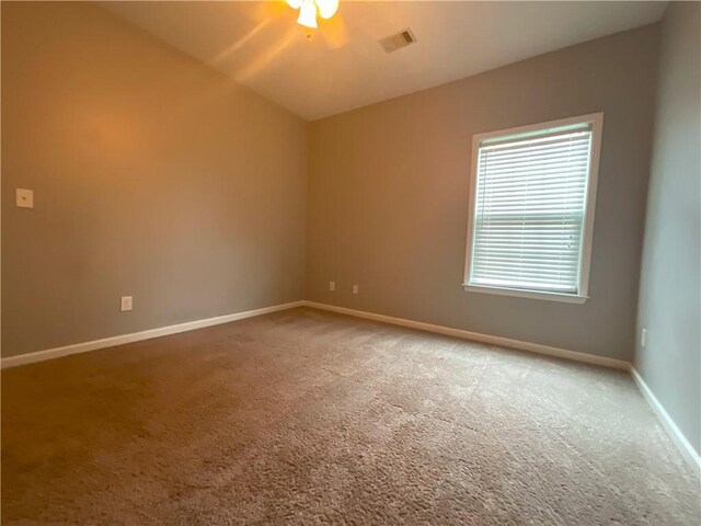 carpeted spare room with ceiling fan