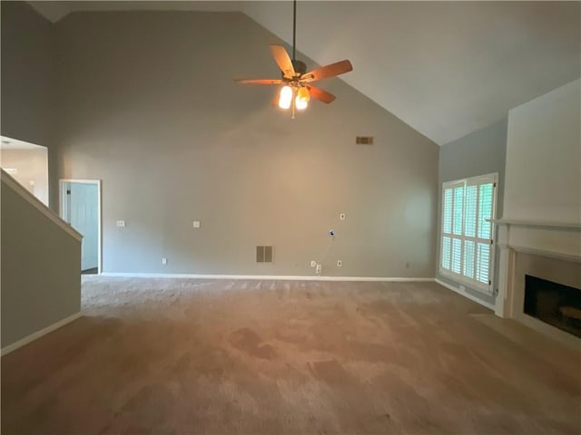 unfurnished living room featuring light colored carpet, high vaulted ceiling, and ceiling fan