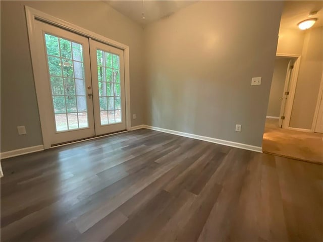 unfurnished room with dark hardwood / wood-style flooring, a wealth of natural light, and french doors