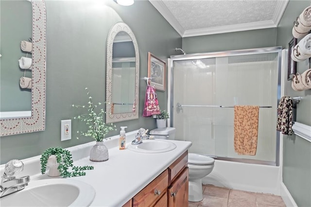 bathroom with a sink, double vanity, toilet, and crown molding